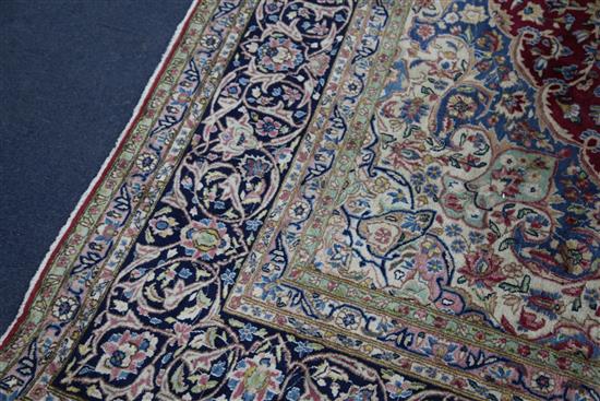 An Isfahan red and ivory ground carpet, 12ft 10in by 9ft 10in.